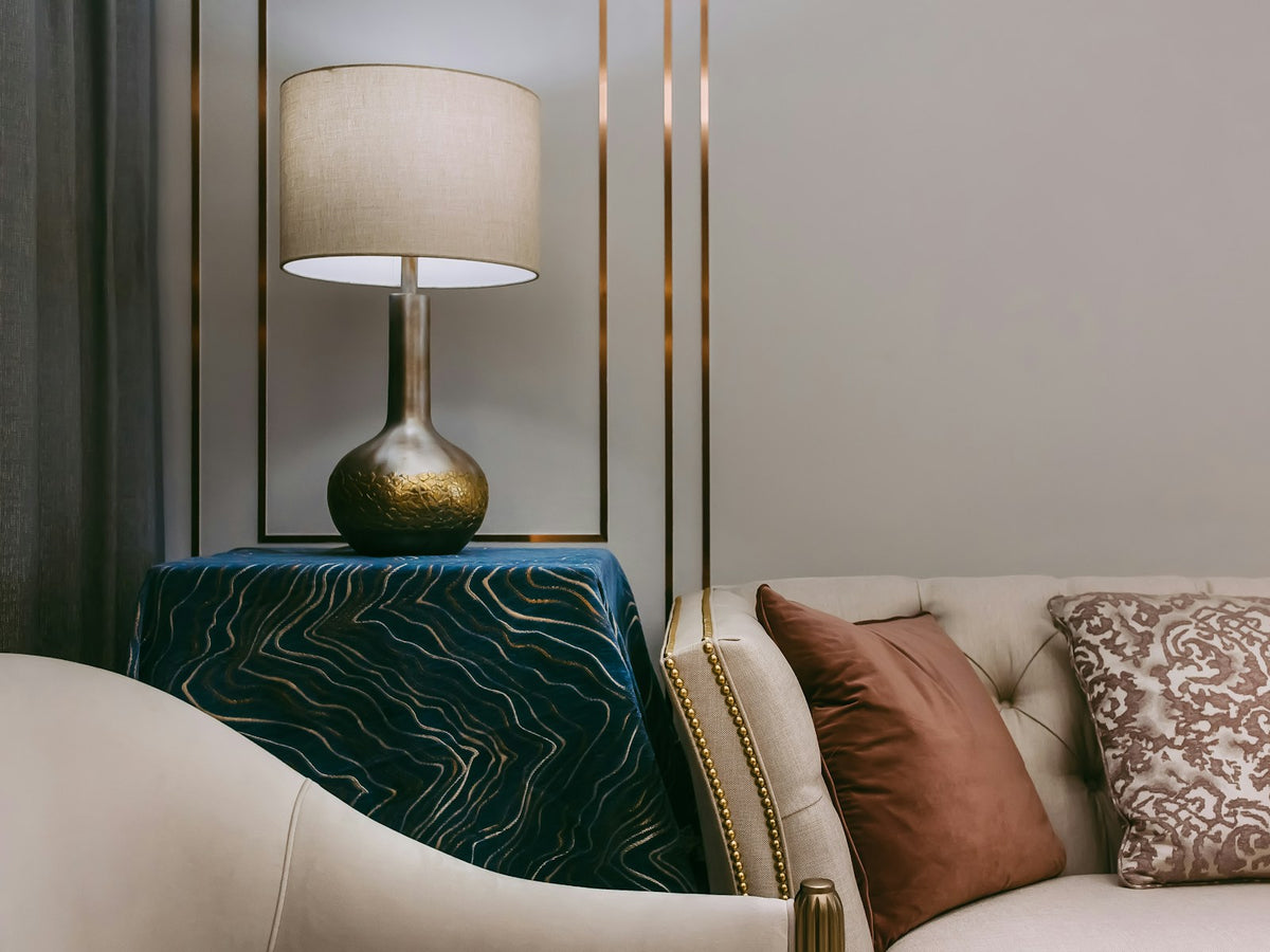 Elegant table lamp beside a velvet sofa